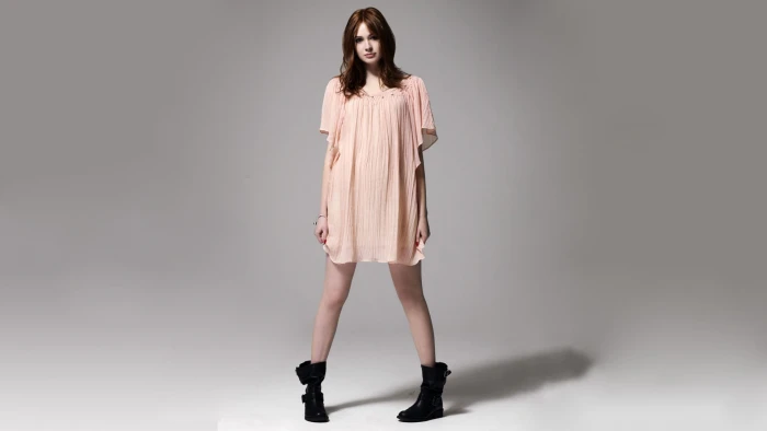 pair of women's black booties Karen Gillan actress boots gray background