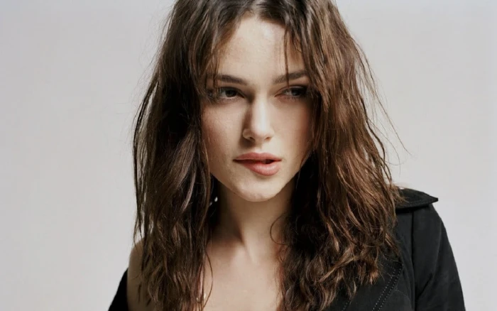 woman in black top while bitting lips Keira Knightley actress