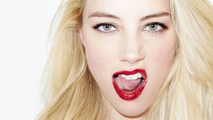 woman in blond hair Amber Heard tongues face actress white background