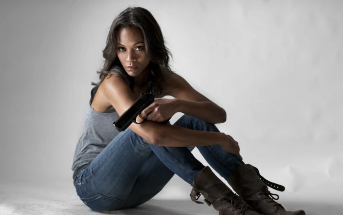 Zoe Saldana women brunette jeans tank top gun weapon