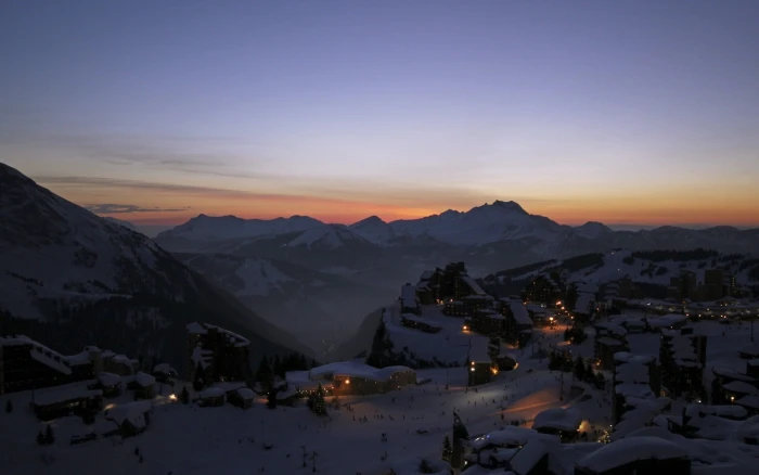 aerial view photography of snowfield village near mountain alps under golden hour 2k