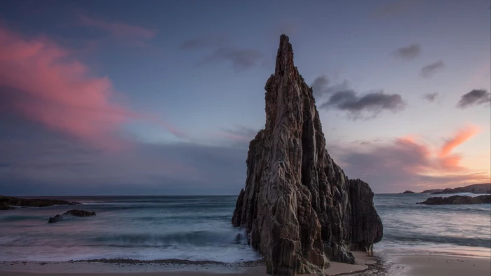 haystack rock cliff shore sea waves sky clouds beach water 2k