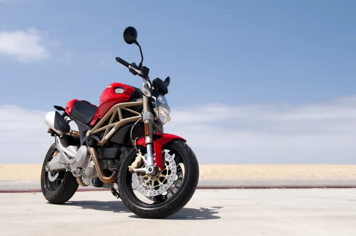 red Ducati Monster beach road sky 2k