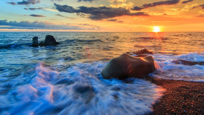 time lapse photography of sea wave splashing on a rack during sunset fangshan