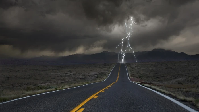 gray and orange road freeway struck by lightning clouds desert 2k