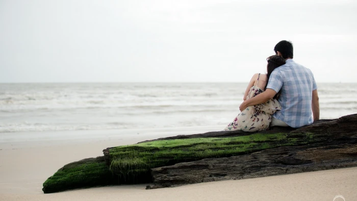 men's blue top beach rock sitting couple hugging sea water 2k