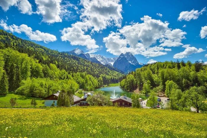 house near body of water lake Germany summer clouds green