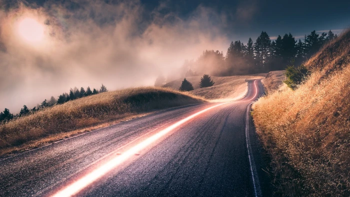 gray asphalt road near trees digital wallpaper nature landscape 2k