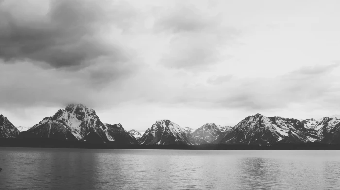 grayscale photography of sea surrounded by mountains nature 2k 4k