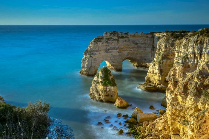 aerial view of rock formation and cliff beside blue ocean algarve 2k