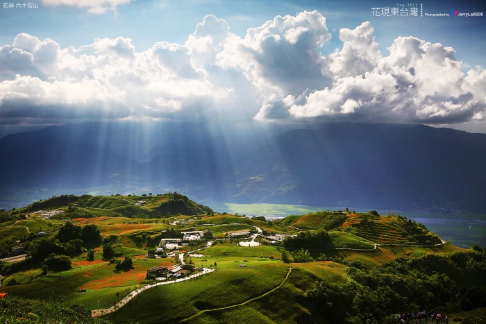 areal photography of town with cumulus nimbus clouds and god rays taiwan 2k