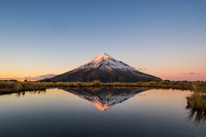 cone shaped volcano in front body of water taranaki pouakai 2k 4k