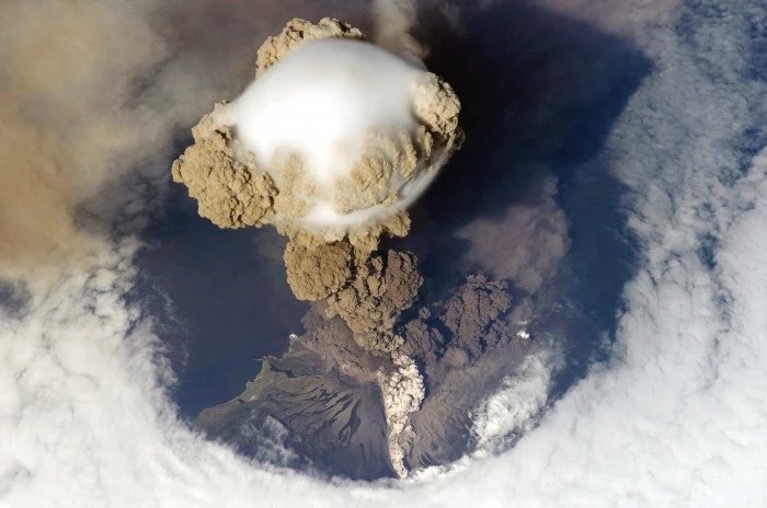 top of volcano eruptions aerial view island smoke clouds 2k