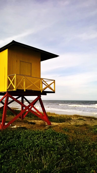 beach land sea architecture water grass sky built structure