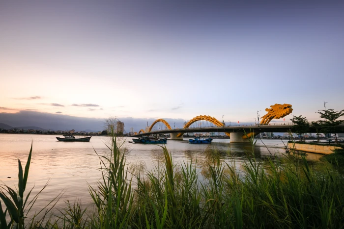 orange dragon bridge over body of water vietnam danang the city 2k 4k