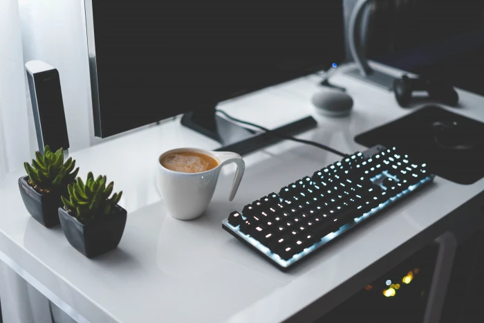 photo of turned on black gaming keyboard beside mug near white ceramic with off monitor 2k 4k 5k