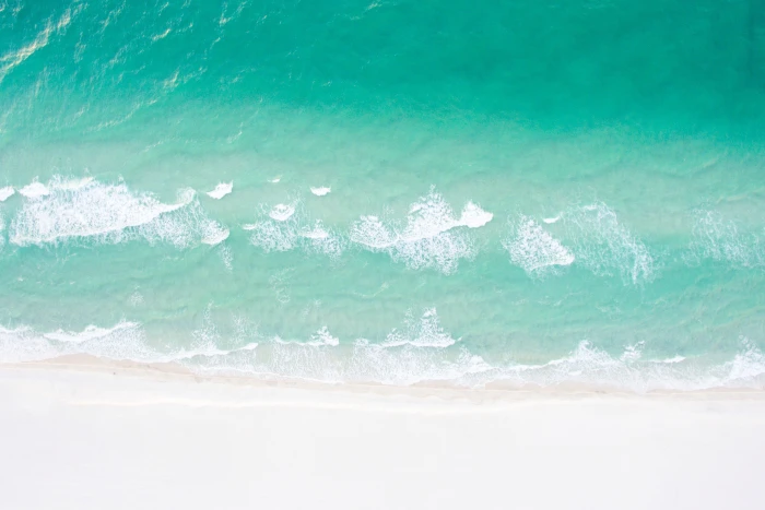 Aerial drone shot of a sandy beach and ocean in the summer nature 2k 4k