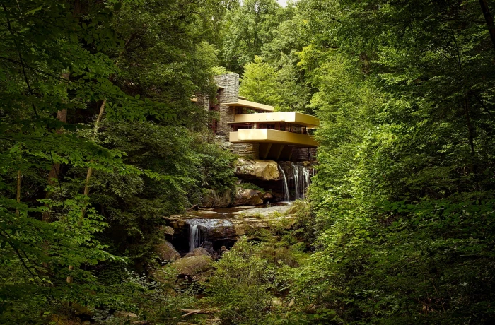 brown house on the middle of forest with water fountain during daytime 2k