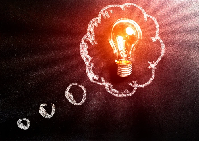 Thought Concept with Light Bulb Over Blackboard art background 2k