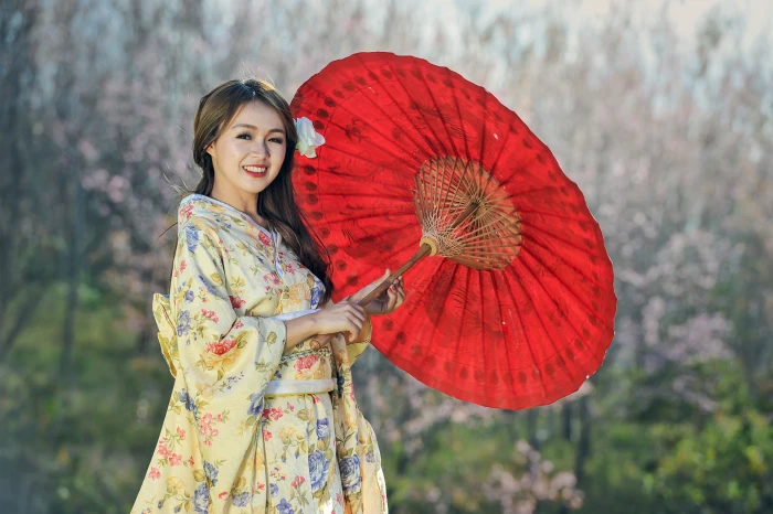 woman in beige floral dress holding oil paper umbrella beauty 2k 4k