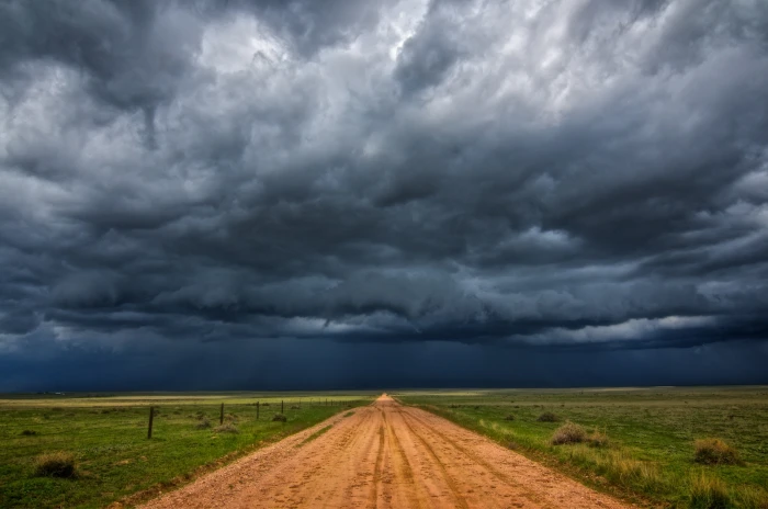 brown dirt road under black clouds landscape nature field 2k 4k