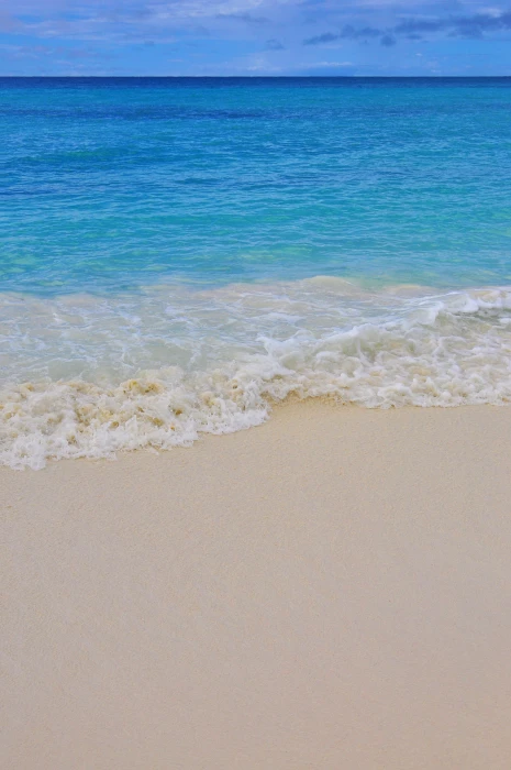 cloudy sky over sea caribbean beach sand wave background 2k
