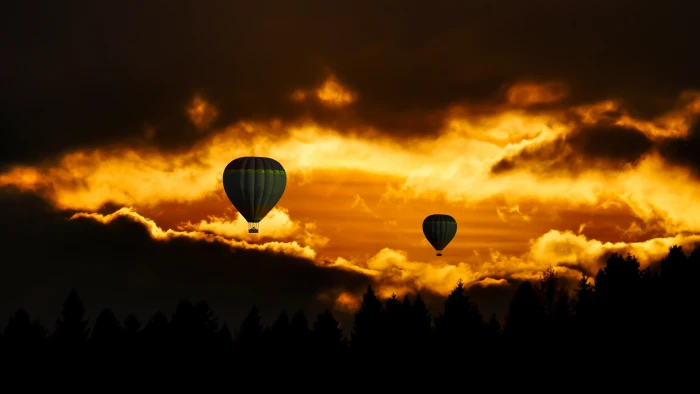 two silhouette of hot air balloons near clouds photo taken during golden hour 2k 4k 5k 8k