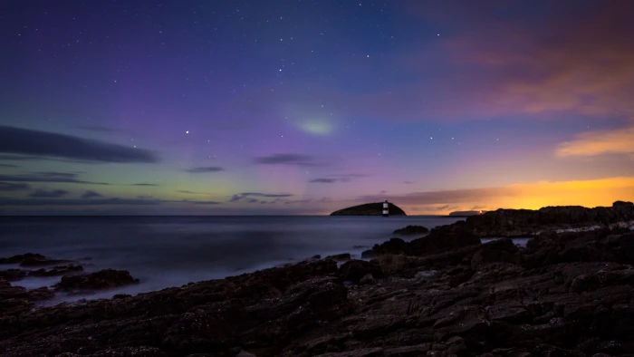 white and black lighthouse near rocks at golden hour penmon 2k 4k 5k