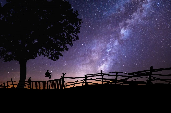 person on swing chair tree near fence photoshop space universe 2k 4k 5k