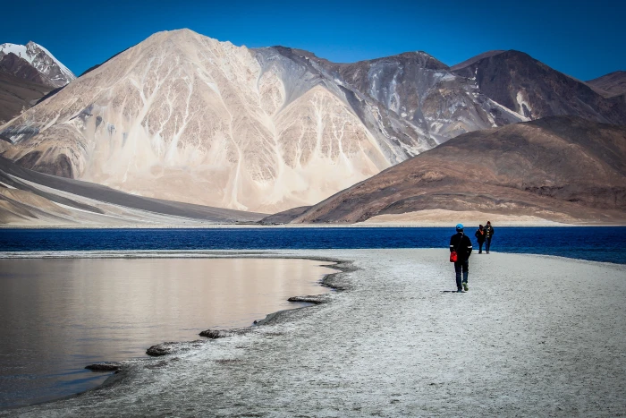 photo of person walking on pathway near mountain ladakh traveler 2k 4k