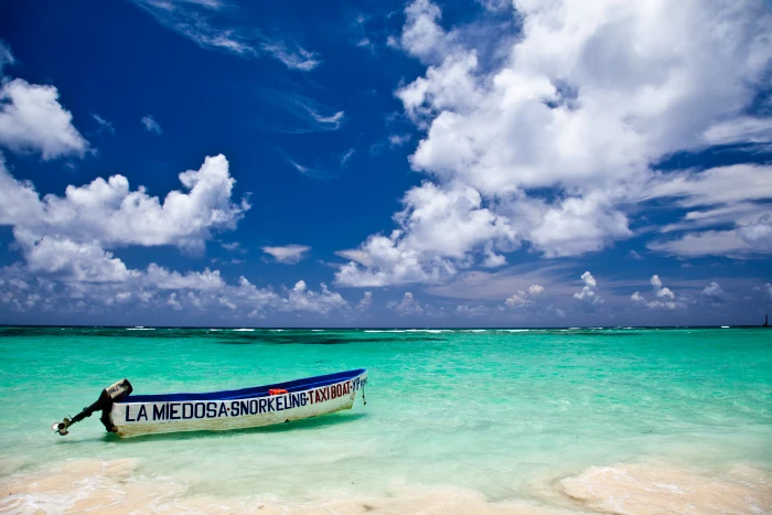 white and blue canoe on seashore during daytime punta cana dominican republic 2k 4k 5k