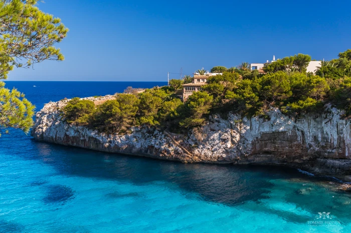 aerial view of house on top a mountain that is covered with blue sea under the sky during daytime mallorca 2k 4k