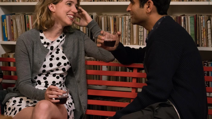 blonde haired woman wearing white and black polka dots dress sitting on red couch 2k 4k 5k