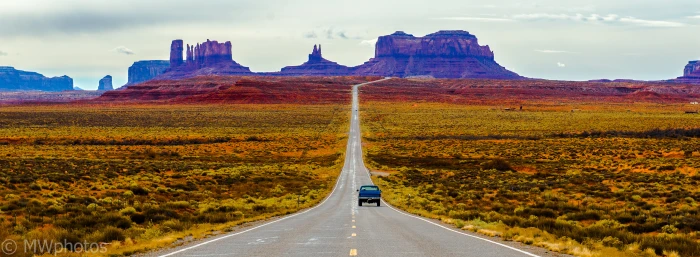 blue car surrounded green grass field and rocky mountain monument valley utah 2k 4k 5k