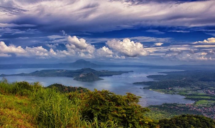 green trees surrounded by body of water under cloudy sky taal lake tagaytay philippines 2k 4k 5k