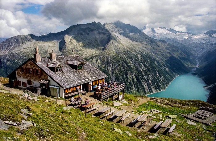 landscape photo of gray concrete house beside mountain zillertal alps mayrhofen 2k