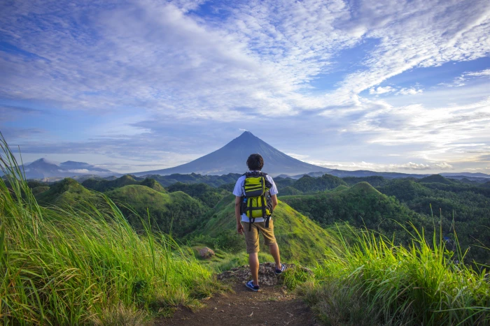 Man Wearing White Shirt Brown Shorts and Green Backpack Standing on Hill 2k 4k 5k