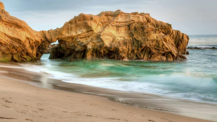 stone arch on beach with waves at daytime Pearl Street wallpaper 2k 4k 5k 8k