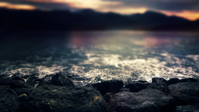 black rocks closeup photo of near body water at dusk 2k