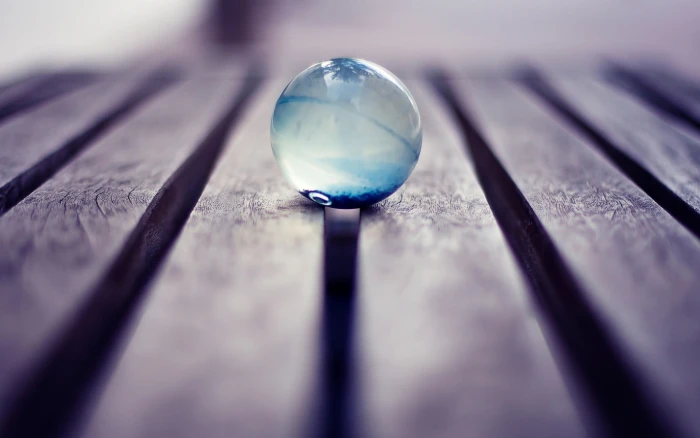 blue glass ball photography macro marble wood wooden surface 2k