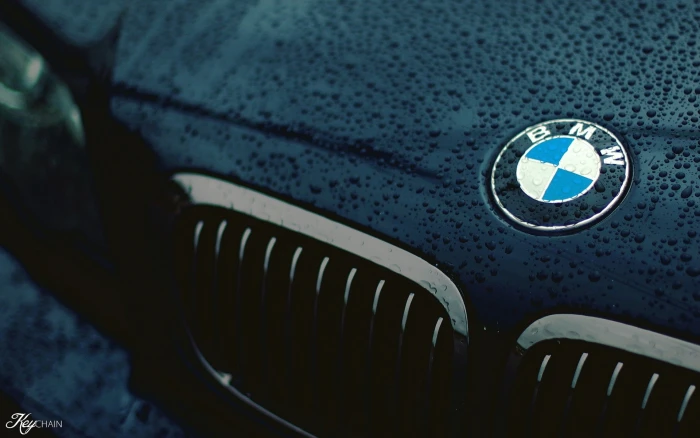 car BMW closeup logo black water drops wet cyan macro 2k