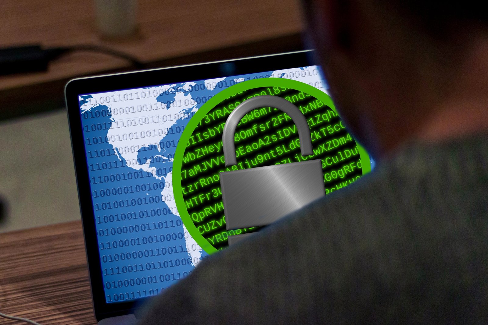person in front of laptop computer ransomware cyber crime malware 2k 4k