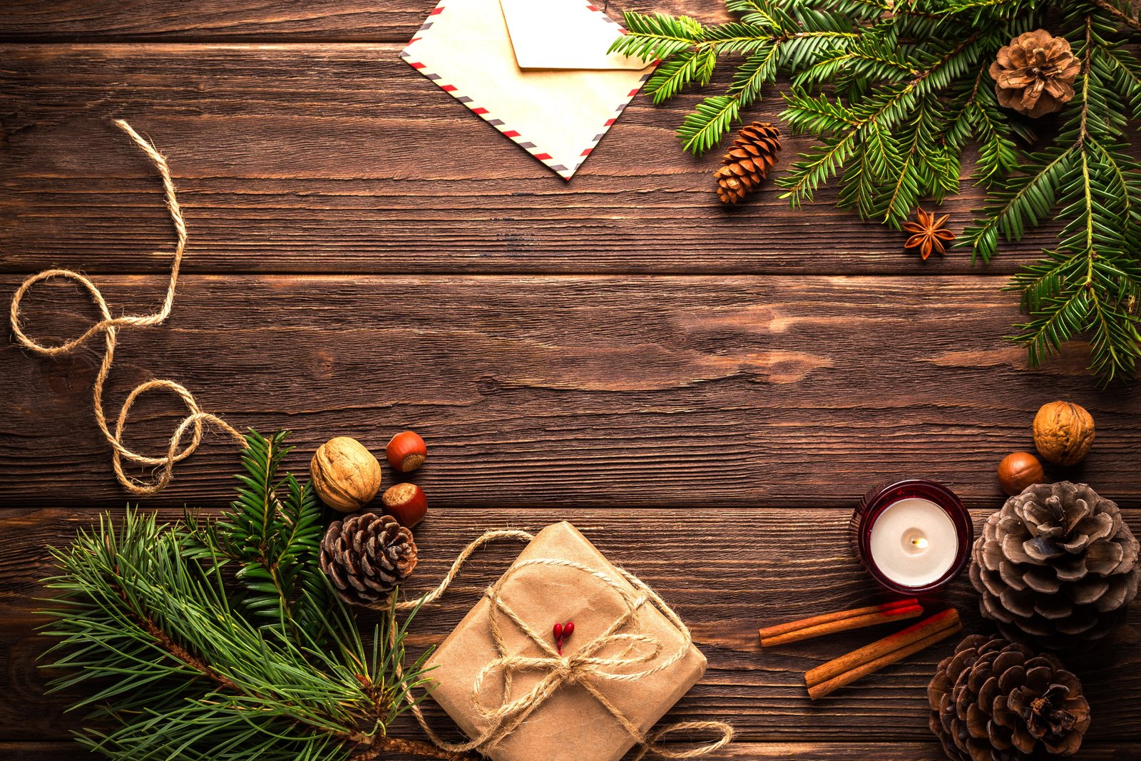 green leaves with accessories on brown wooden surface christmas 2k 4k 5k