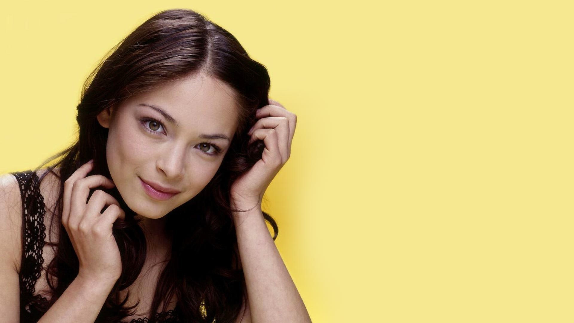Kristin Kreuk actress yellow background smiling portrait