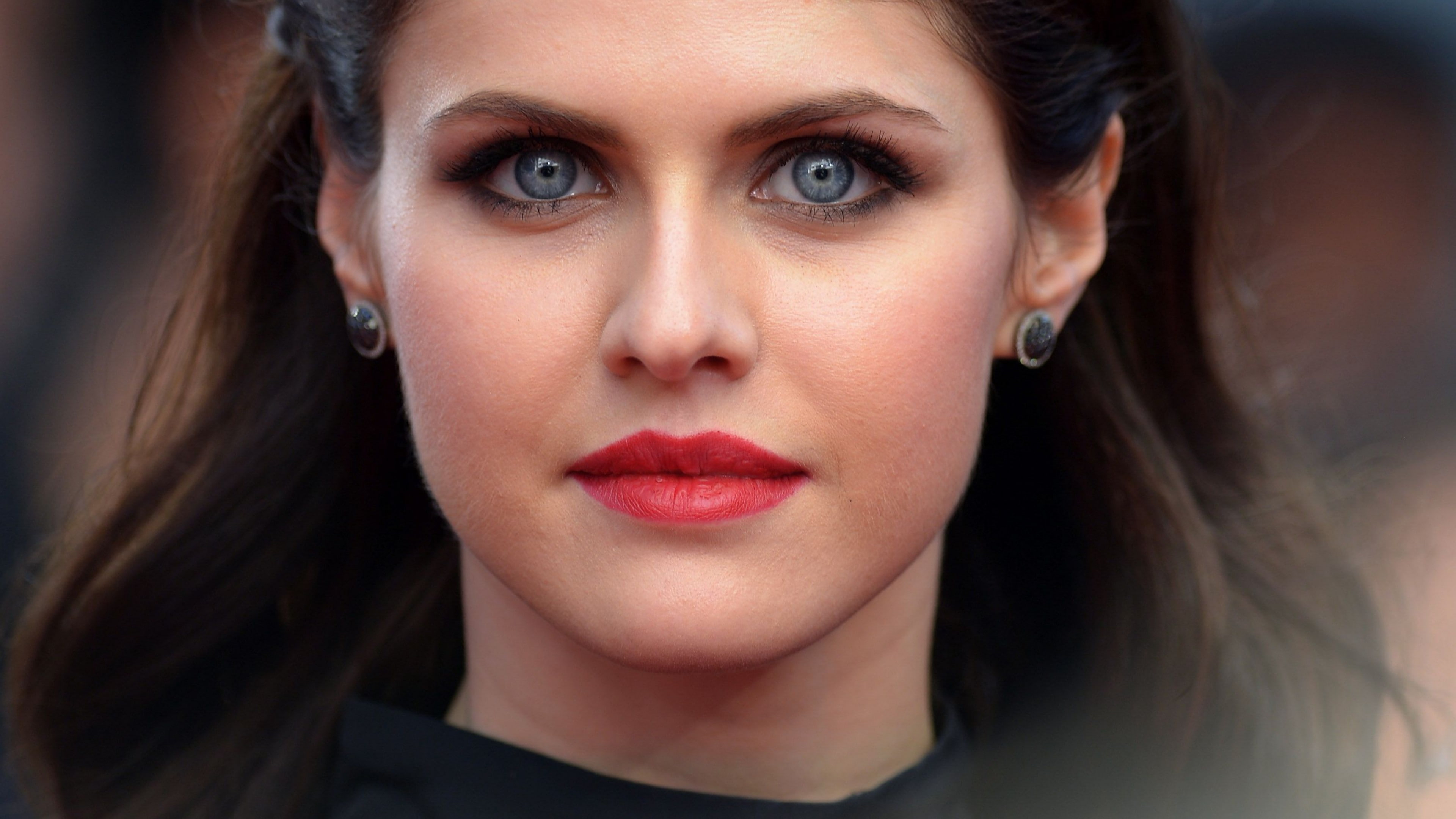 woman wearing black dress and fur cardigan laying on brown oval tub 2k
