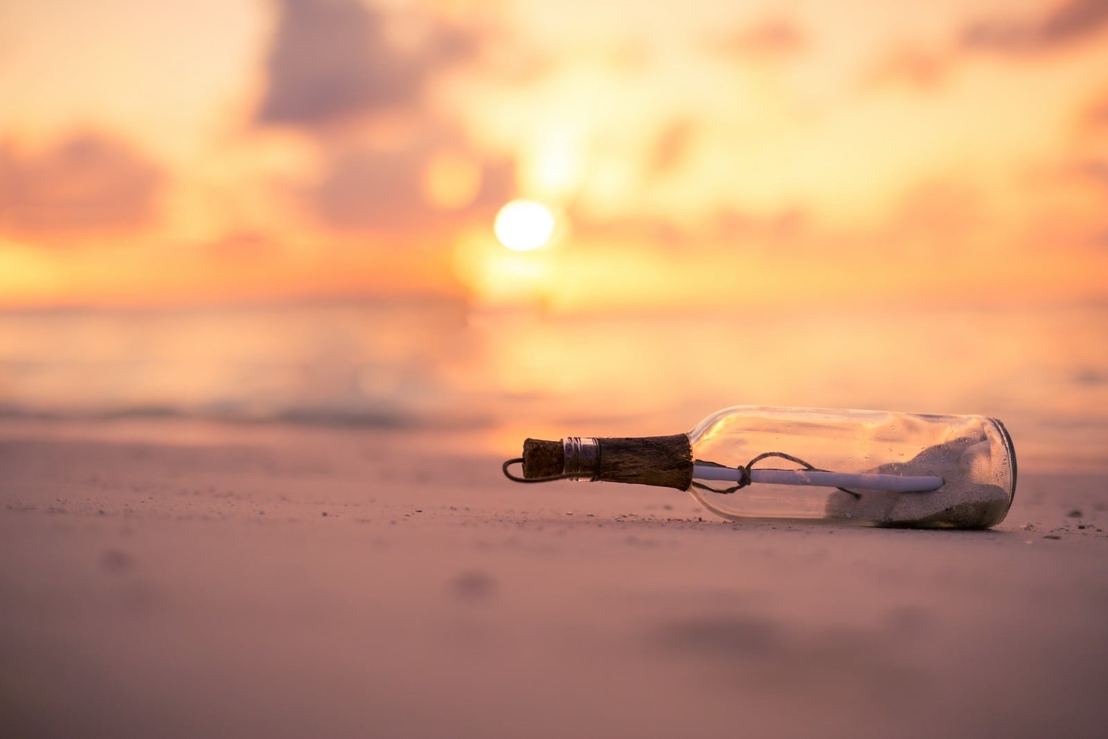 clear glass bottle selective focus photography wishing during sunset 2k
