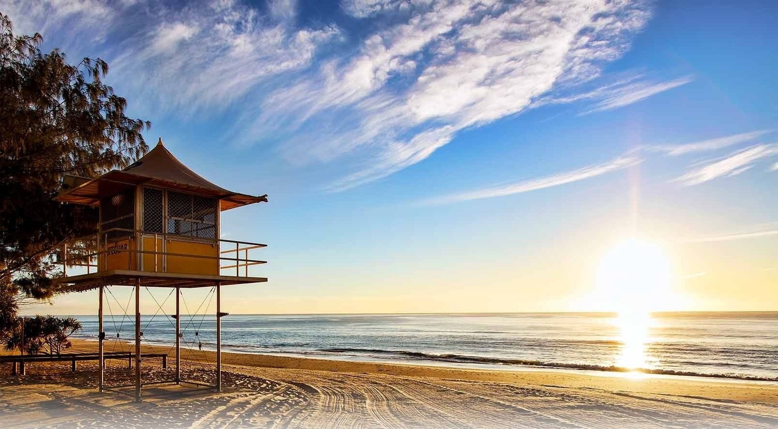 brown wooden hut beach lifeguard stands sand trees Australia 2k