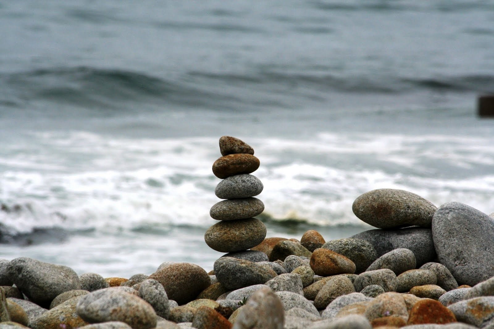 stacked stones with body of water in the background 17 mile drive 2k