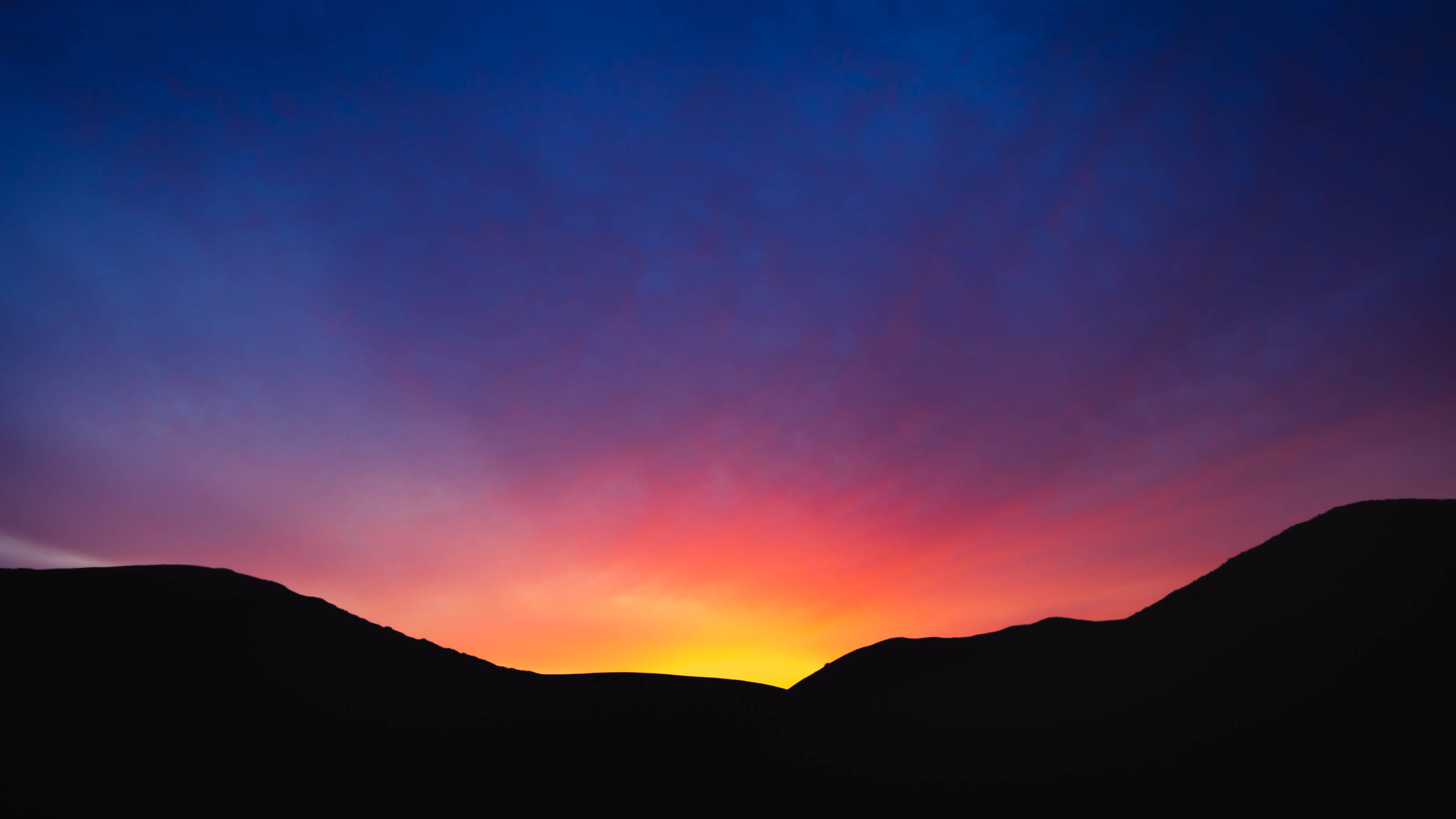 silhouette photo of mountain land scape colours sunset down 2k