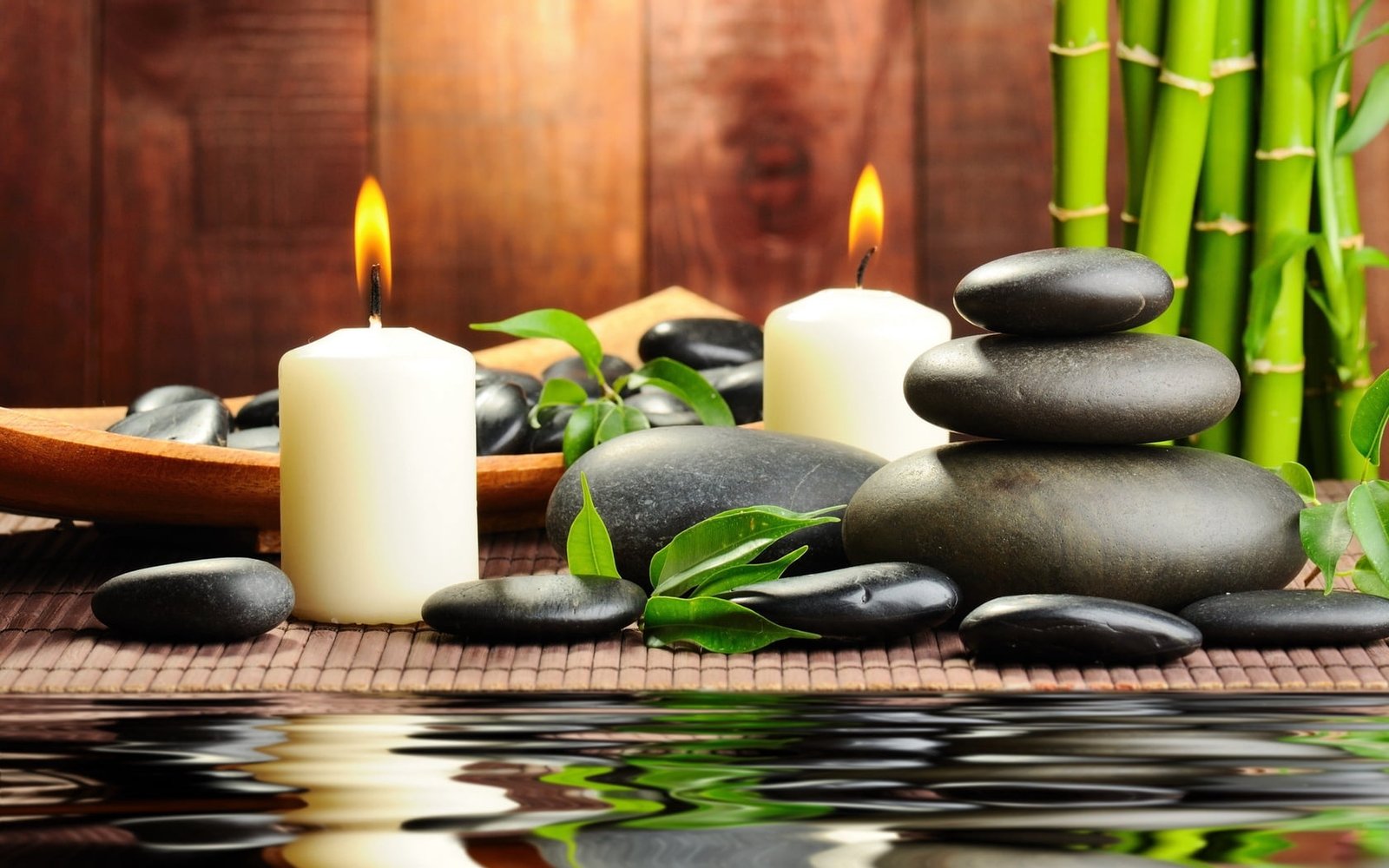 two white candles stones aromatherapy spa water bamboo massage 2k